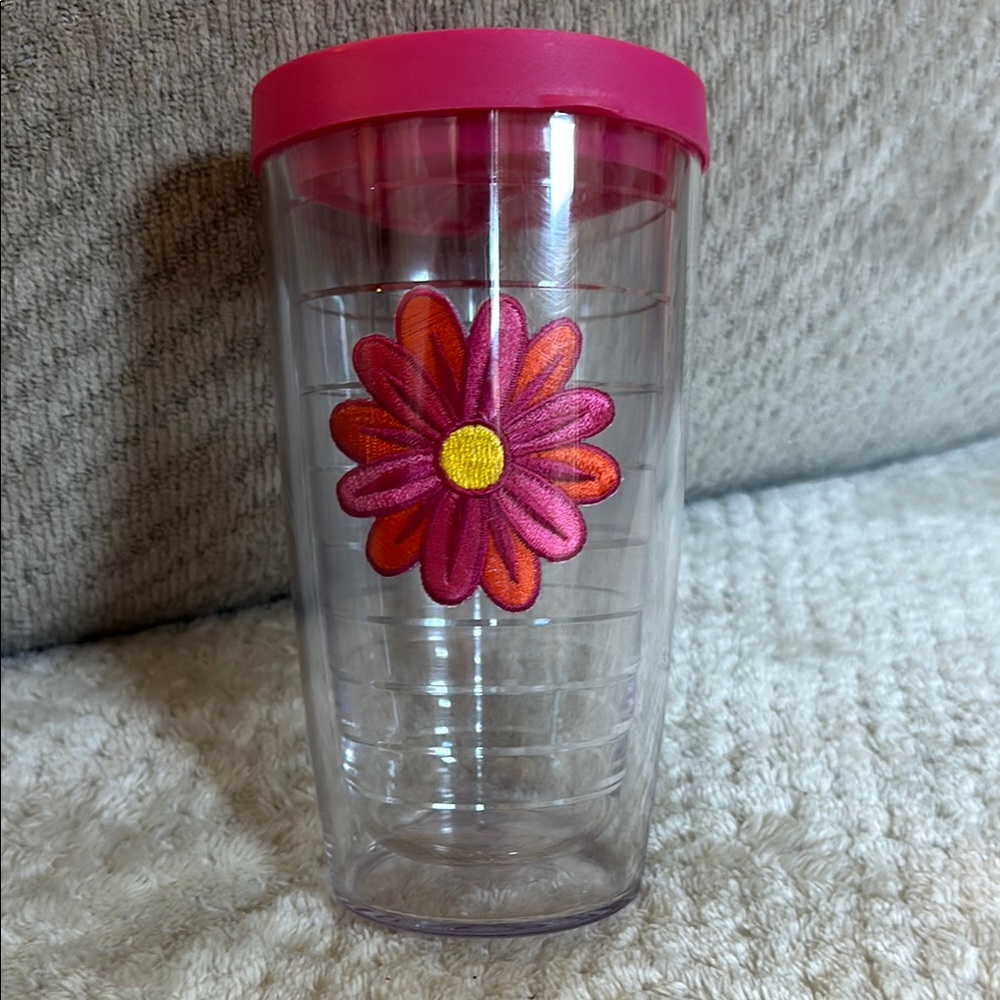 Tervis tumbler with decorative flower. Dishwasher safe.